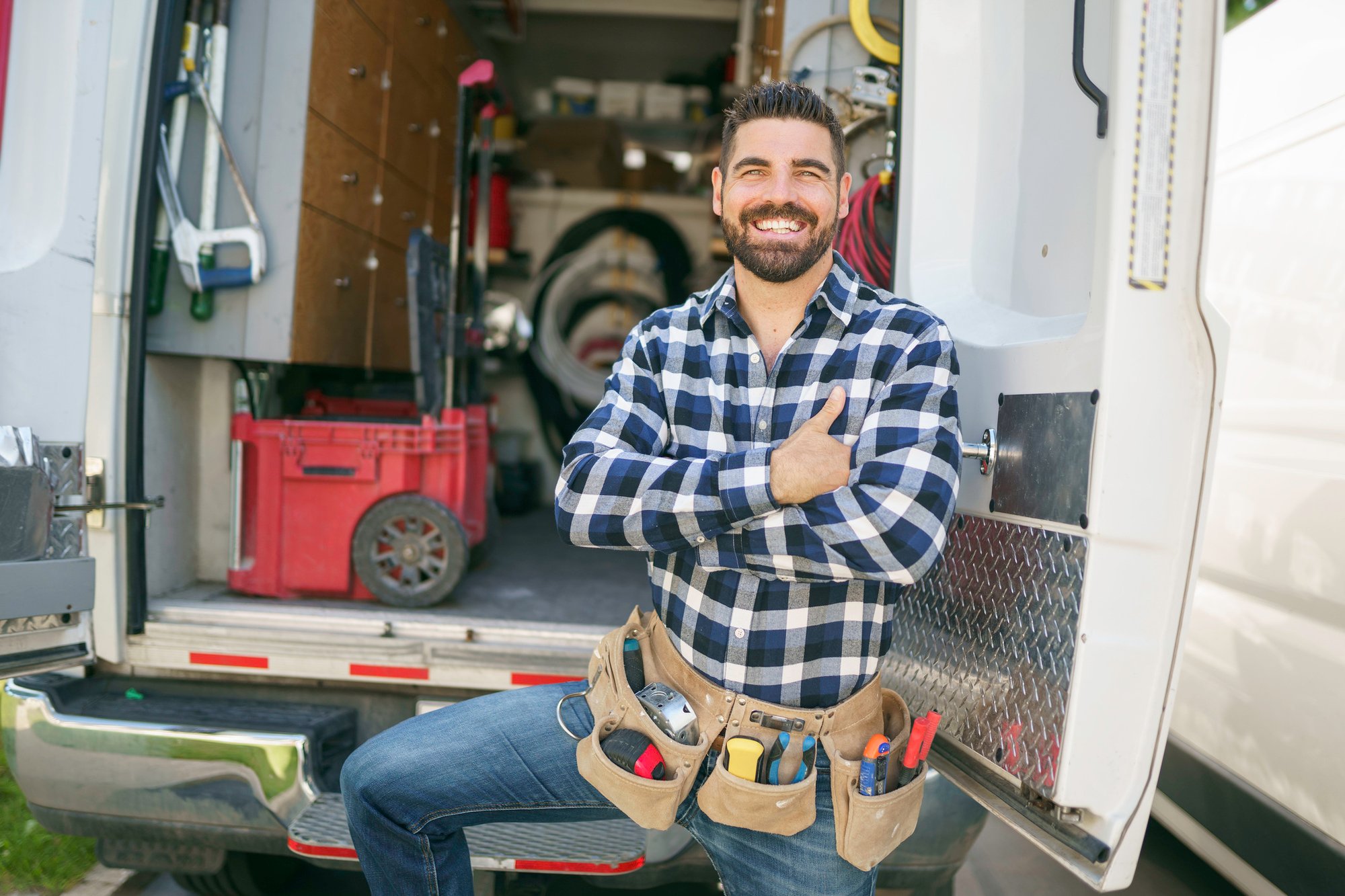 Happy electrician in front of his van Happy electrician in front of his van